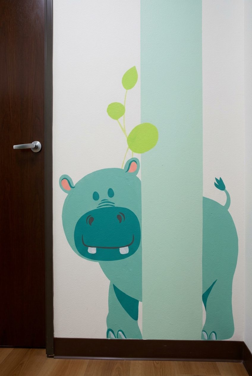Hippo mural peeking around a corner in the Alta Loma Pediatrics hallway