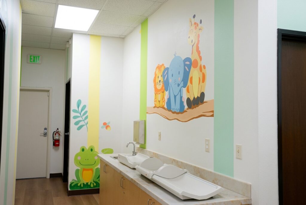 Infant scale and measuring station with animal murals at Alta Loma Pediatrics